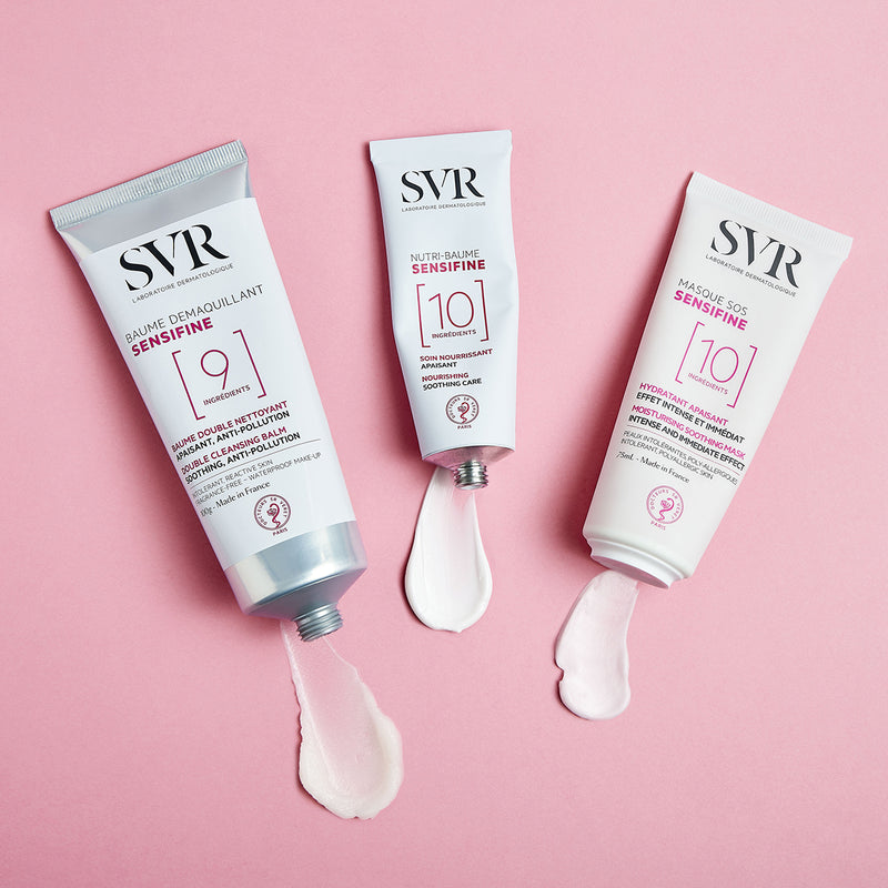 Gama de productos SENSIFINE de hidrtación para pieles sensibles del Baume Demaquillant, Nutre-Baume y Masque SOS en fondo rosa